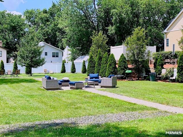 269 Main Street, Unit 2 Little Ferry, NJ 07643 - Photo 27 of 37 a view of backyard with table and chairs and potted plants and large trees