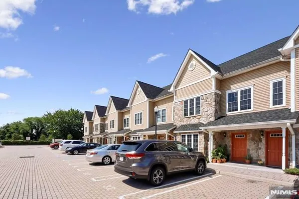 a view of a cars park in front of a building