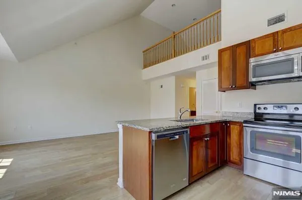 a kitchen with stainless steel appliances granite countertop a stove and a sink