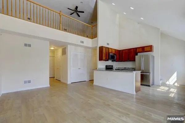 a kitchen with stainless steel appliances a refrigerator and a stove top oven