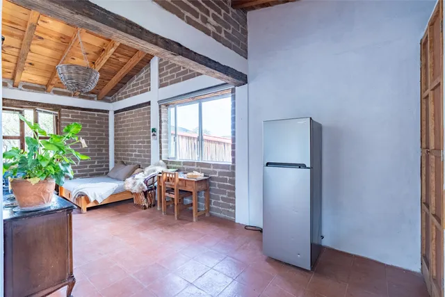 a bedroom with bed and a mirror