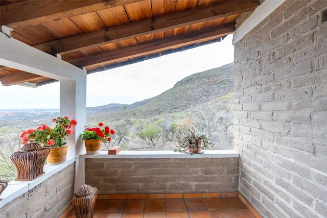 a living room with furniture a wooden floor and next to a window