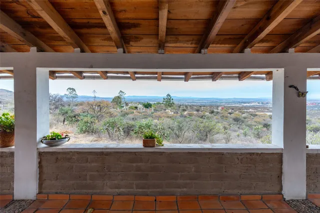 a living room with furniture and a dining table with wooden floor