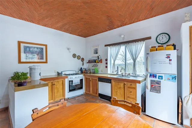 a bedroom with a bed a bookshelf and a window