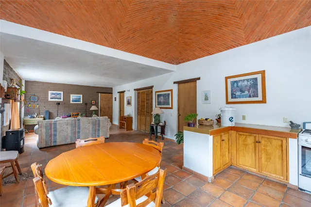 a view of a patio with chairs and potted plants