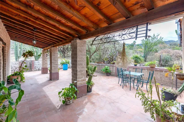 a view of a patio with table and chairs and potted plants