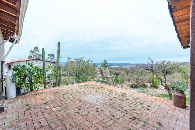 a living room with furniture and next to a dining table with painted walls