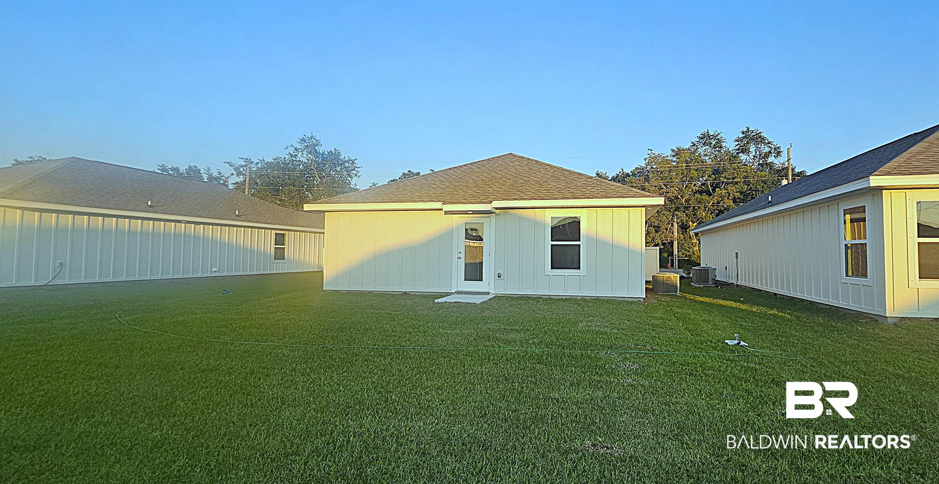 1084 South Bay Street Foley, AL 36535 - Photo 5 of 31 Back of house with central air condition unit and a lawn