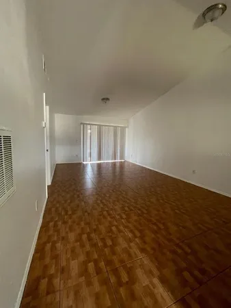 an empty room with wooden floor