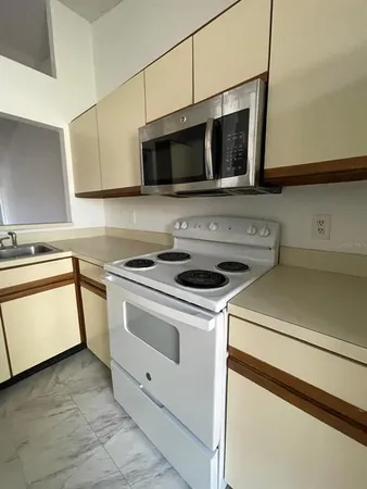 a kitchen with a stove and a microwave