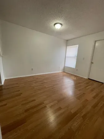 an empty room with wooden floor