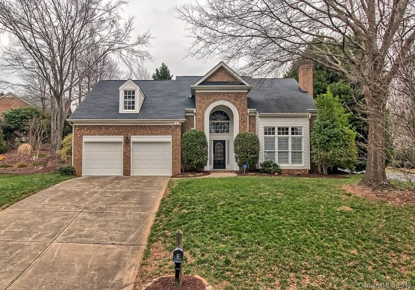9731 Deer Spring Lane Charlotte, NC 28210 - Photo 1 of 26 a front view of a house with a yard and garage