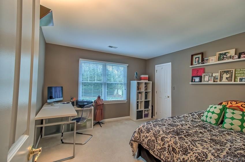 9731 Deer Spring Lane Charlotte, NC 28210 - Photo 14 of 26 a bedroom with a bed and a desk