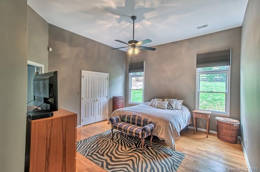 9731 Deer Spring Lane Charlotte, NC 28210 - Photo 8 of 26 a bedroom with a bed and a chandelier