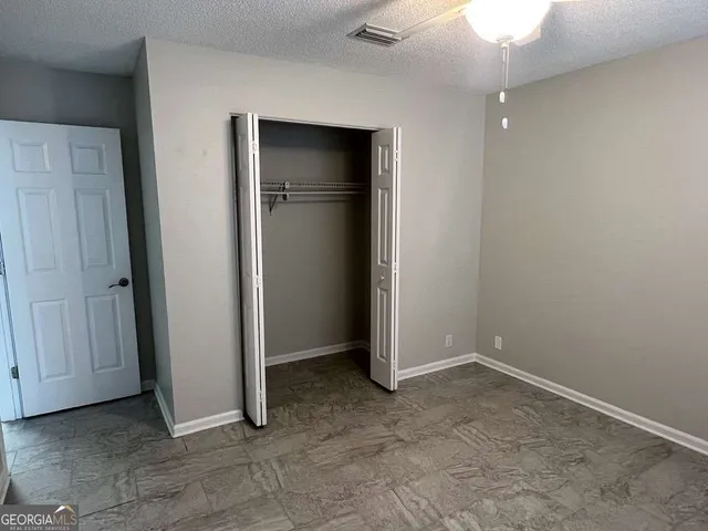an empty room with closet area