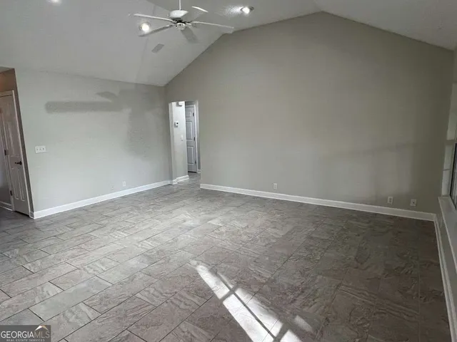 en empty room with windows and entrance