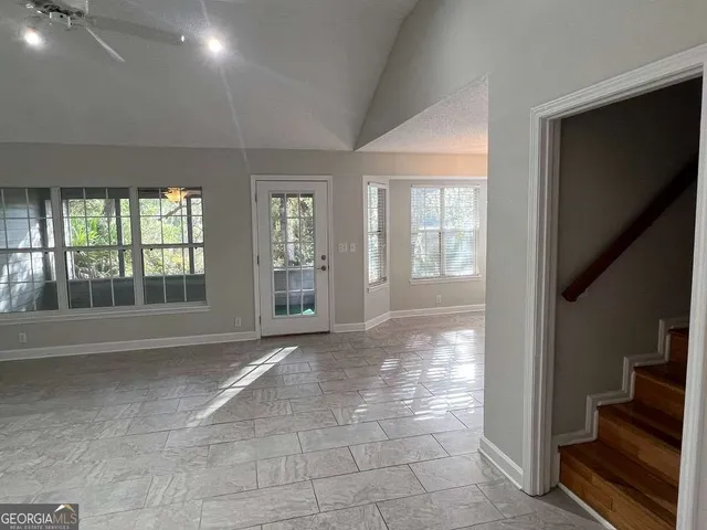 a view of an entryway with wooden floor and a livingroom