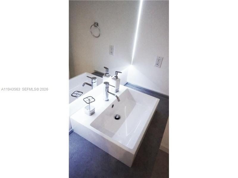 100 Lincoln Road, Unit 420 Miami Beach, FL 33139 - Photo 16 of 25 a bathroom with a sink and a mirror