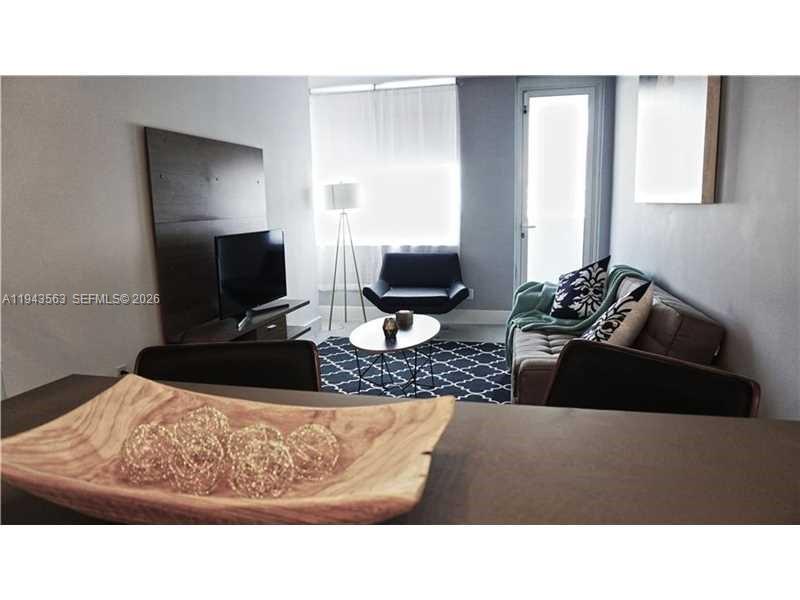 100 Lincoln Road, Unit 420 Miami Beach, FL 33139 - Photo 5 of 25 a living room with furniture and a flat screen tv