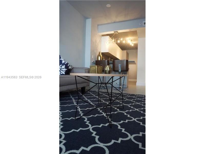 100 Lincoln Road, Unit 420 Miami Beach, FL 33139 - Photo 6 of 25 a living room with a rug and a painting on the wall