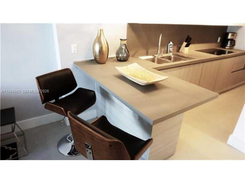 100 Lincoln Road, Unit 420 Miami Beach, FL 33139 - Photo 7 of 25 a kitchen with a sink cabinets and wooden floor
