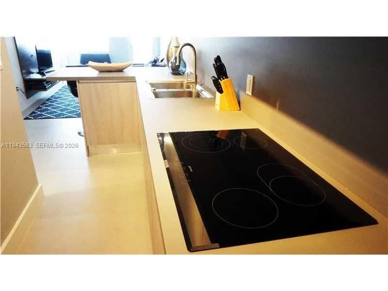 100 Lincoln Road, Unit 420 Miami Beach, FL 33139 - Photo 8 of 25 a kitchen with a sink and a stove
