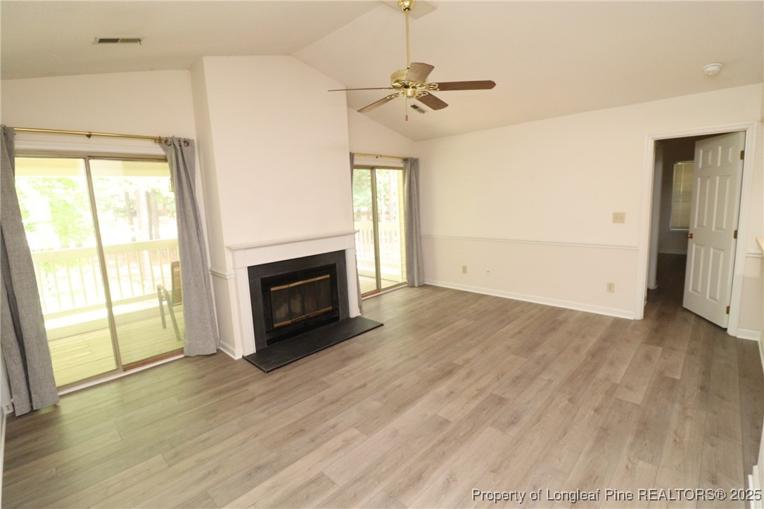 6120 Sunpointe Drive, Unit 205 Raleigh, NC 27606 - Photo 14 of 32 a view of empty room with wooden floor and fireplace