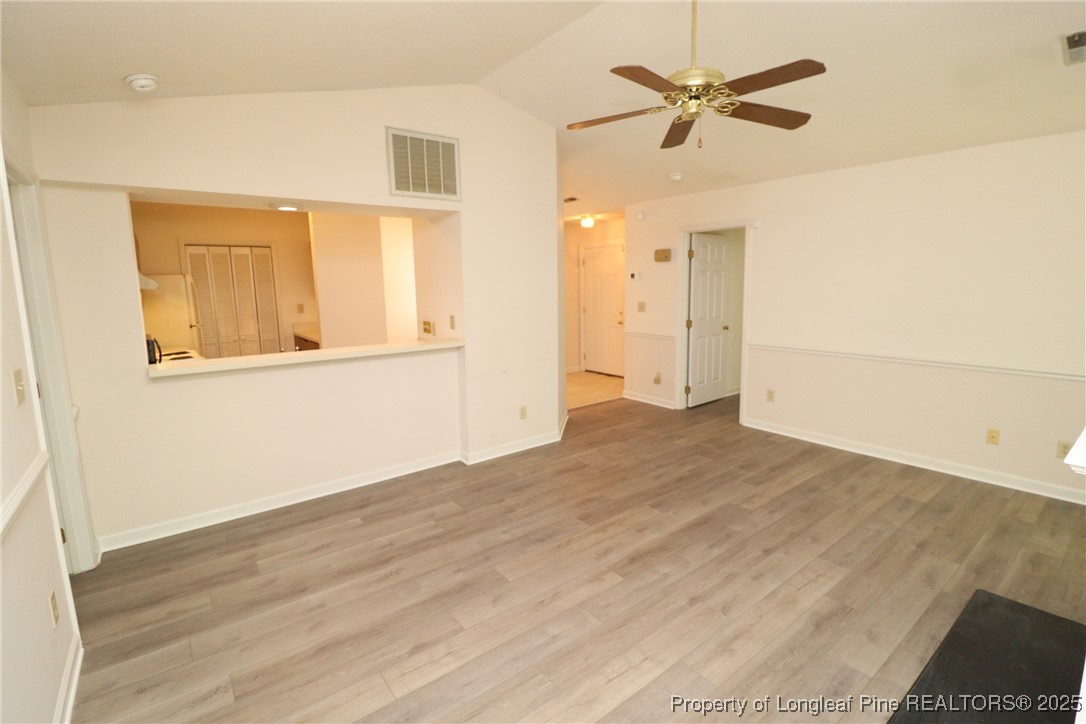 6120 Sunpointe Drive, Unit 205 Raleigh, NC 27606 - Photo 16 of 32 a view of empty room with wooden floor and ceiling fan