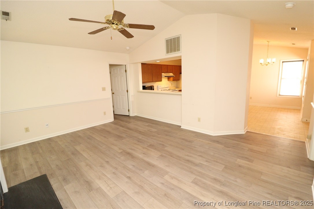 6120 Sunpointe Drive, Unit 205 Raleigh, NC 27606 - Photo 17 of 32 a view of a bedroom with wooden floor and a ceiling fan
