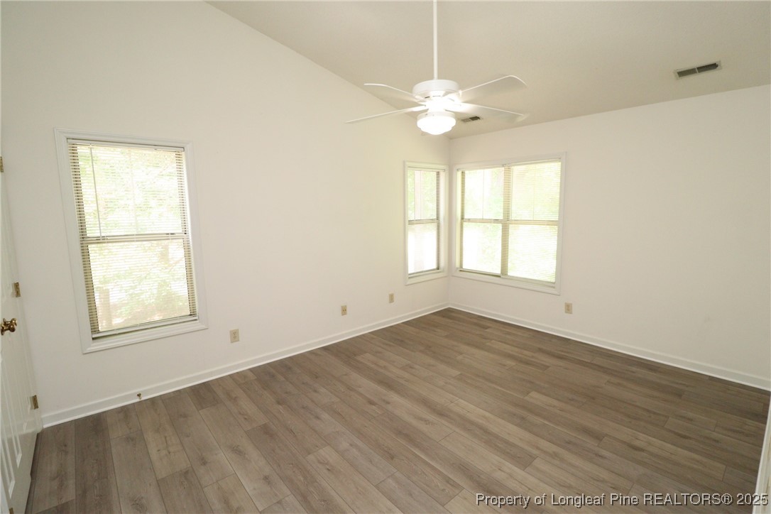 6120 Sunpointe Drive, Unit 205 Raleigh, NC 27606 - Photo 18 of 32 an empty room with wooden floor and windows