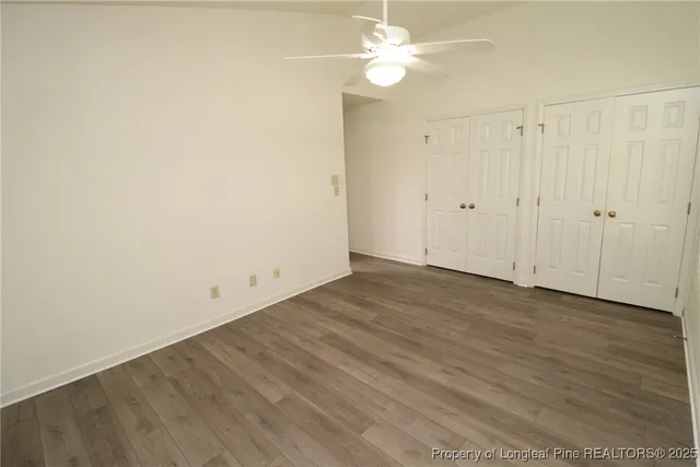 a view of a room with wooden floor