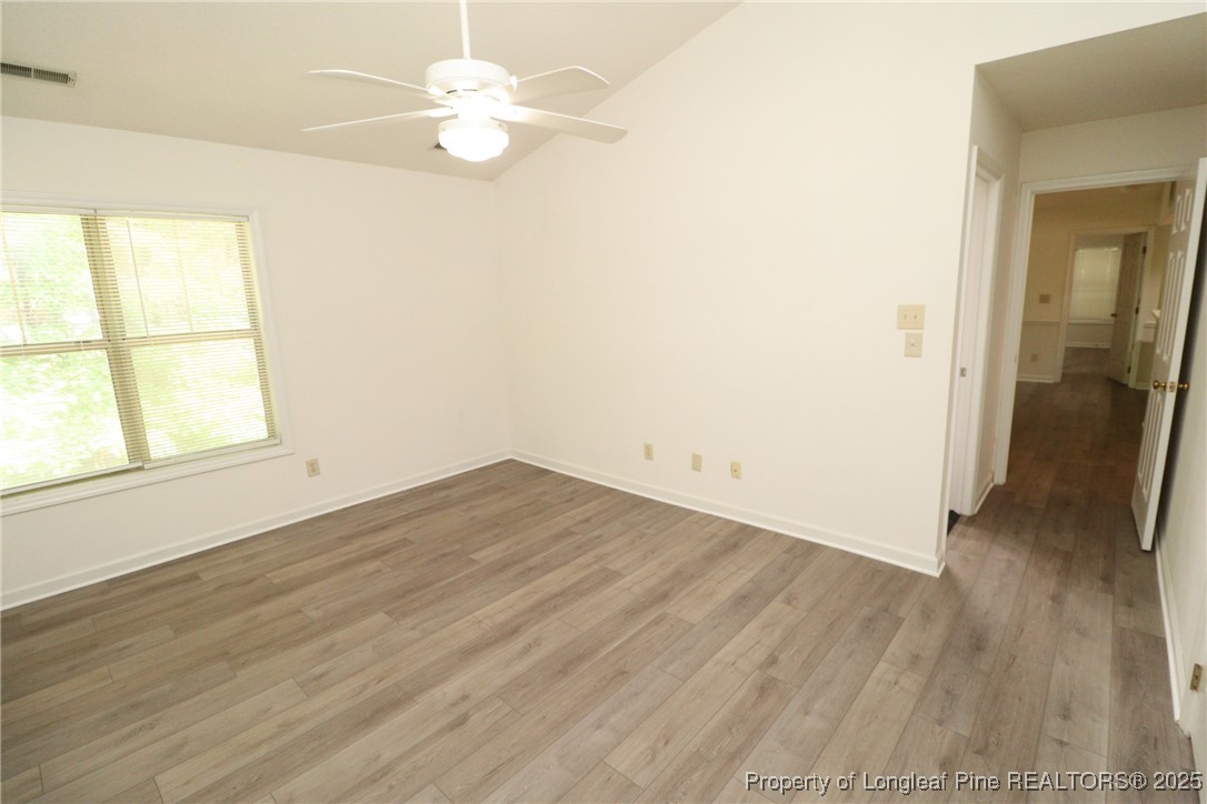 6120 Sunpointe Drive, Unit 205 Raleigh, NC 27606 - Photo 21 of 32 wooden floor in an empty room with a window