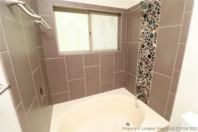 a bathroom with a bathtub and shower