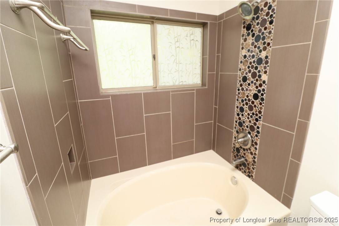6120 Sunpointe Drive, Unit 205 Raleigh, NC 27606 - Photo 23 of 32 a bathroom with a bathtub and shower