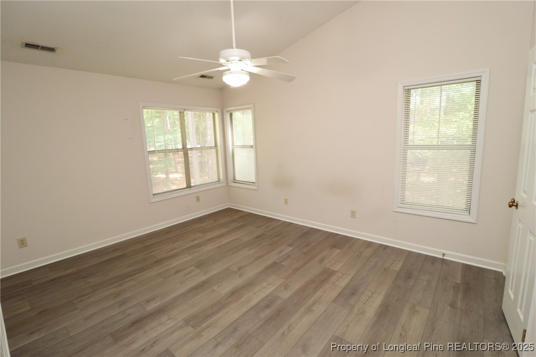 6120 Sunpointe Drive, Unit 205 Raleigh, NC 27606 - Photo 25 of 32 an empty room with wooden floor and windows