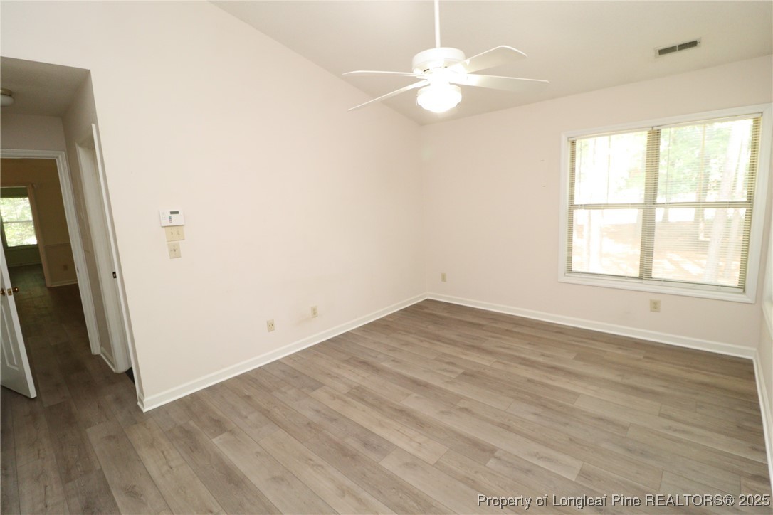 6120 Sunpointe Drive, Unit 205 Raleigh, NC 27606 - Photo 26 of 32 an empty room with wooden floor and window