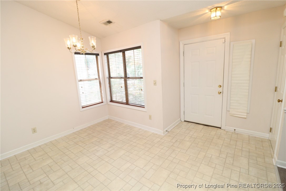 6120 Sunpointe Drive, Unit 205 Raleigh, NC 27606 - Photo 3 of 32 an empty room with windows and closet