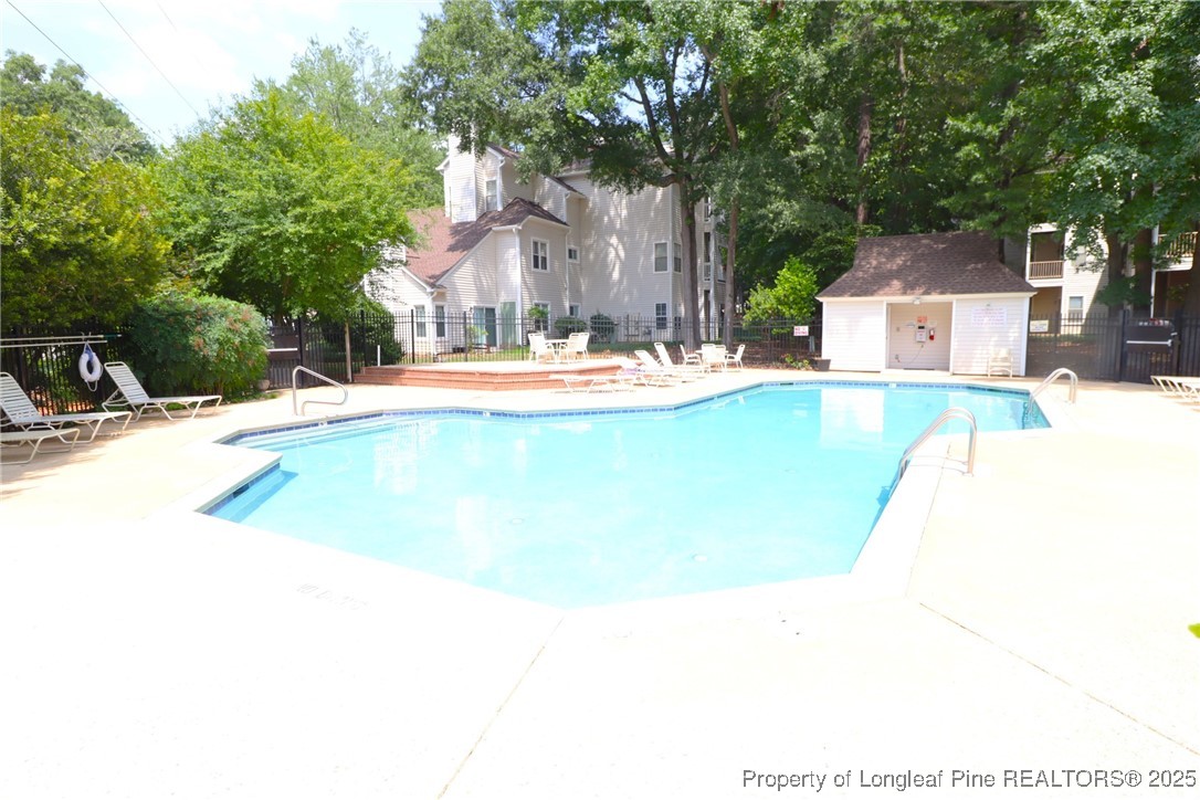 6120 Sunpointe Drive, Unit 205 Raleigh, NC 27606 - Photo 32 of 32 a view of a house with pool and sitting area