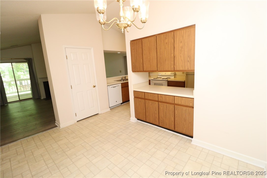 6120 Sunpointe Drive, Unit 205 Raleigh, NC 27606 - Photo 5 of 32 a kitchen with a sink appliances and cabinets