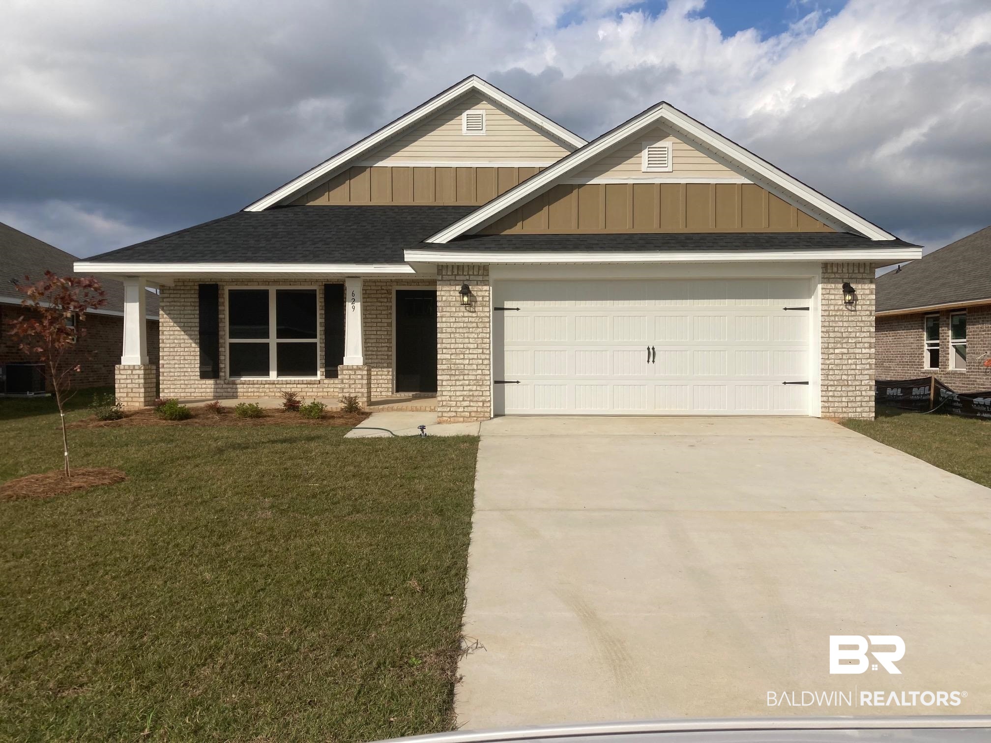 629 Revere Street Foley, AL 36535 - Photo 1 of 30 Craftsman house featuring central AC unit, a front yard, and a garage
