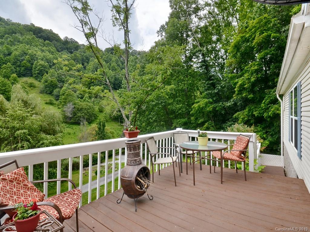 613 Turkey Creek Road Clyde, NC 28721 - Photo 14 of 18 a view of a deck with furniture and trees