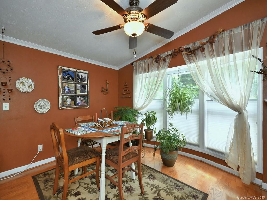 613 Turkey Creek Road Clyde, NC 28721 - Photo 5 of 18 a view of a dining room with furniture and a potted plant