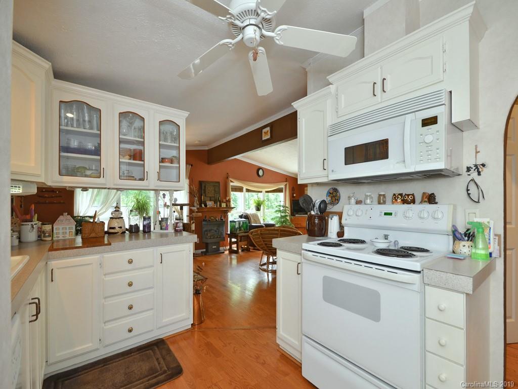613 Turkey Creek Road Clyde, NC 28721 - Photo 8 of 18 a kitchen with white cabinets and white appliances