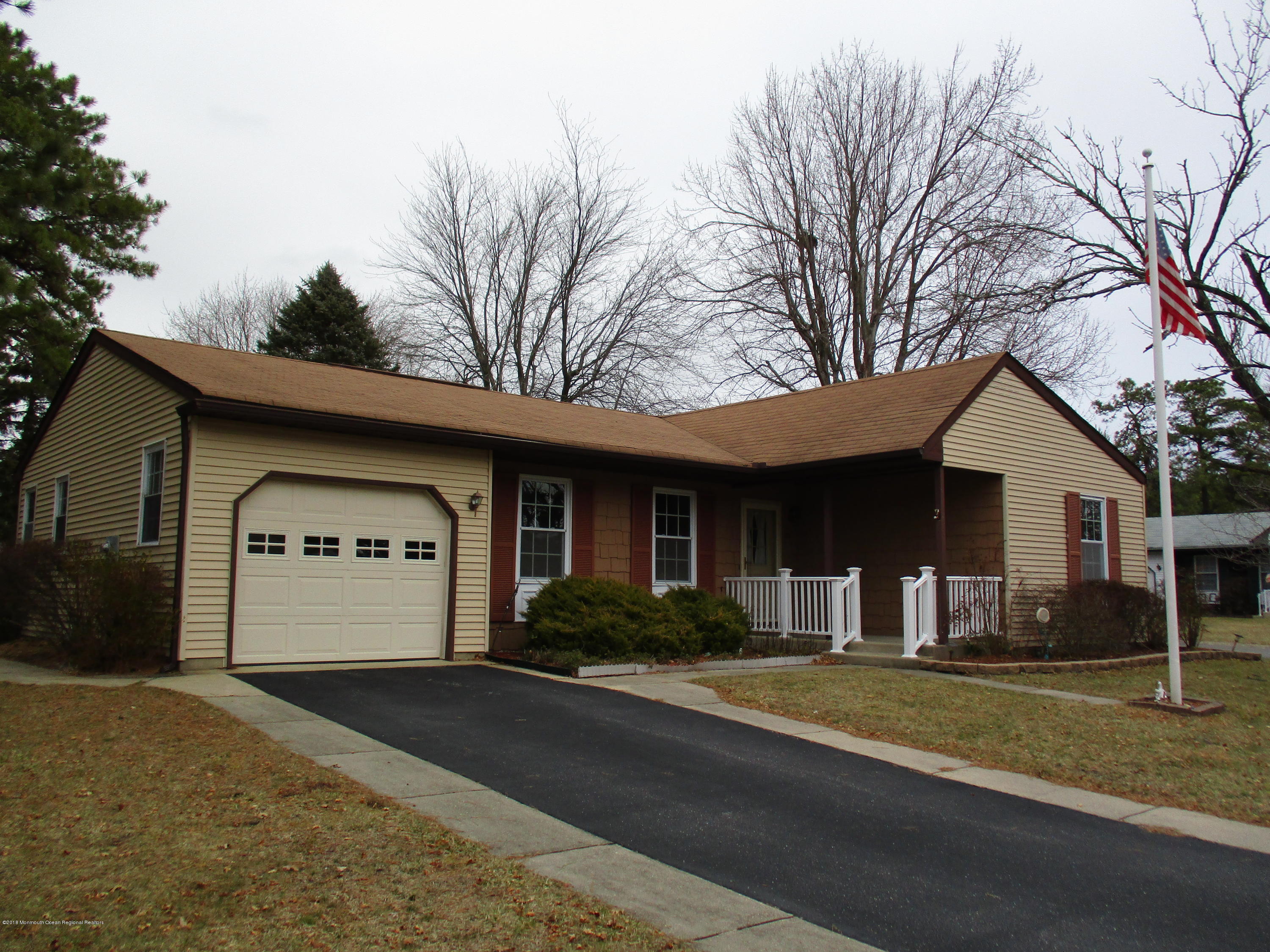 85 Sunset Road, Unit 60 Whiting, NJ 08759 - Photo 1 of 18 a front view of a house with a yard and garage