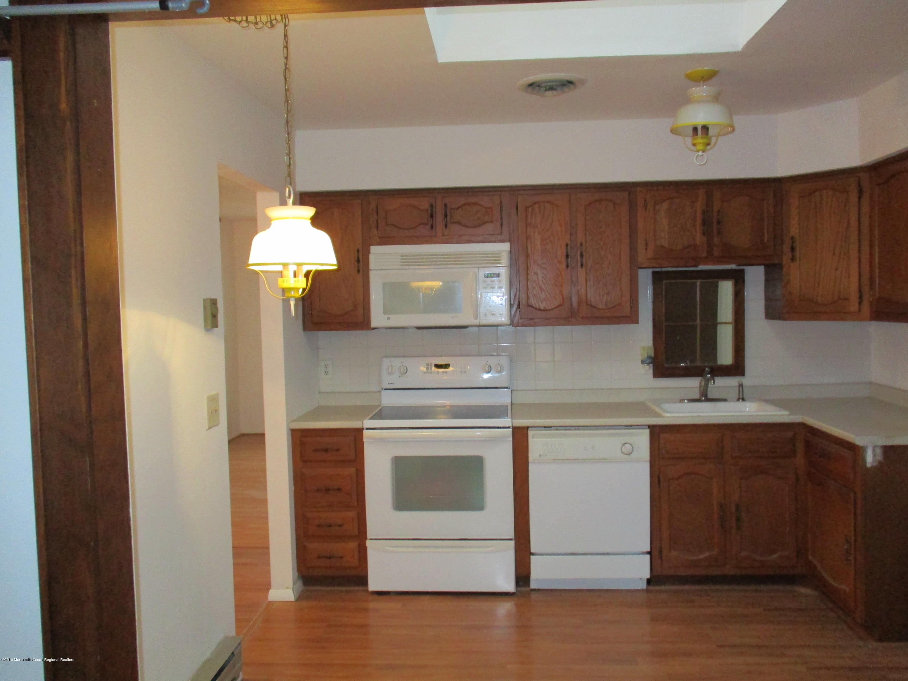 85 Sunset Road, Unit 60 Whiting, NJ 08759 - Photo 2 of 18 a kitchen with a sink cabinets and appliances