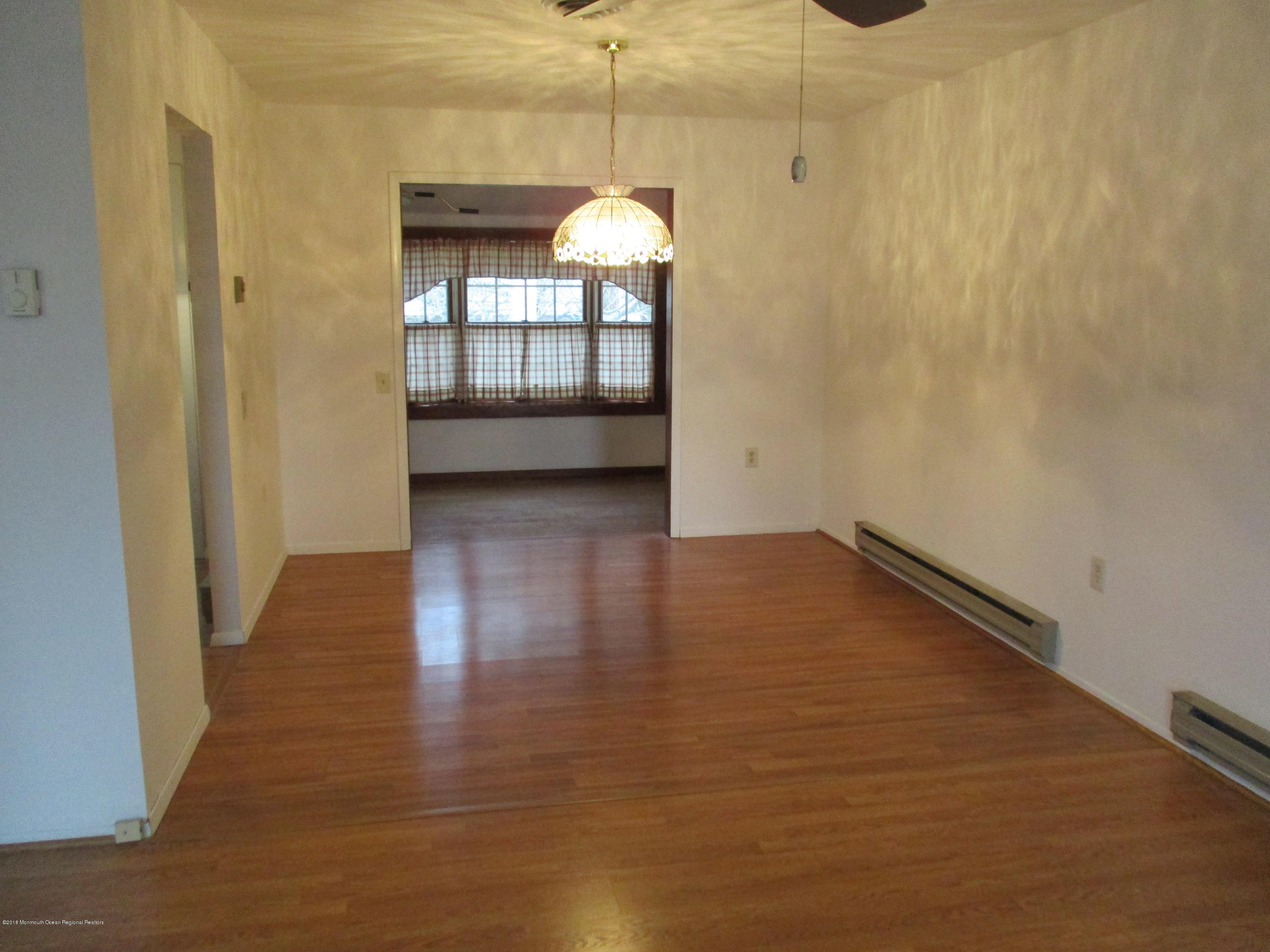 85 Sunset Road, Unit 60 Whiting, NJ 08759 - Photo 6 of 18 a view of a room with wooden floor and door