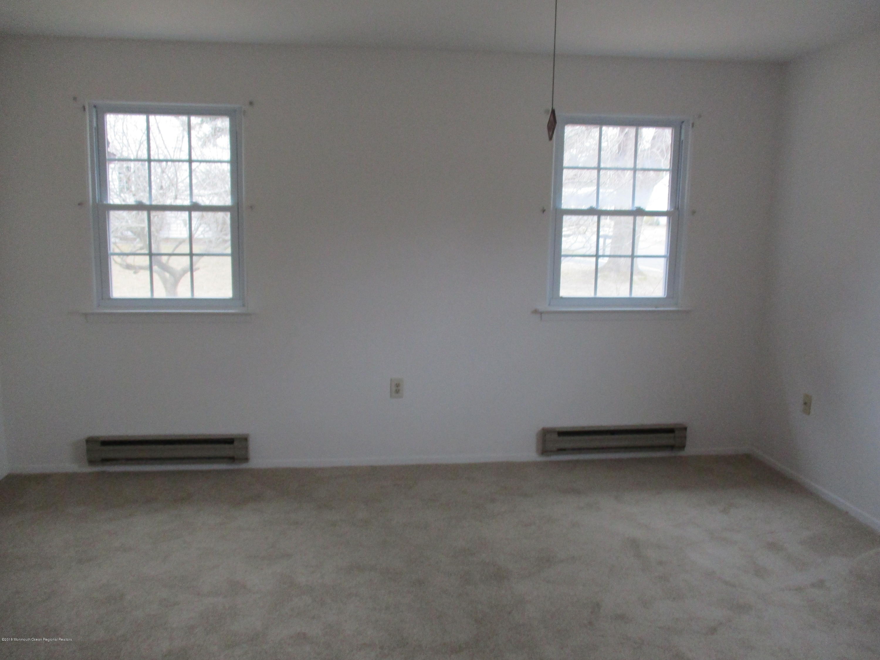 85 Sunset Road, Unit 60 Whiting, NJ 08759 - Photo 7 of 18 an empty room with windows