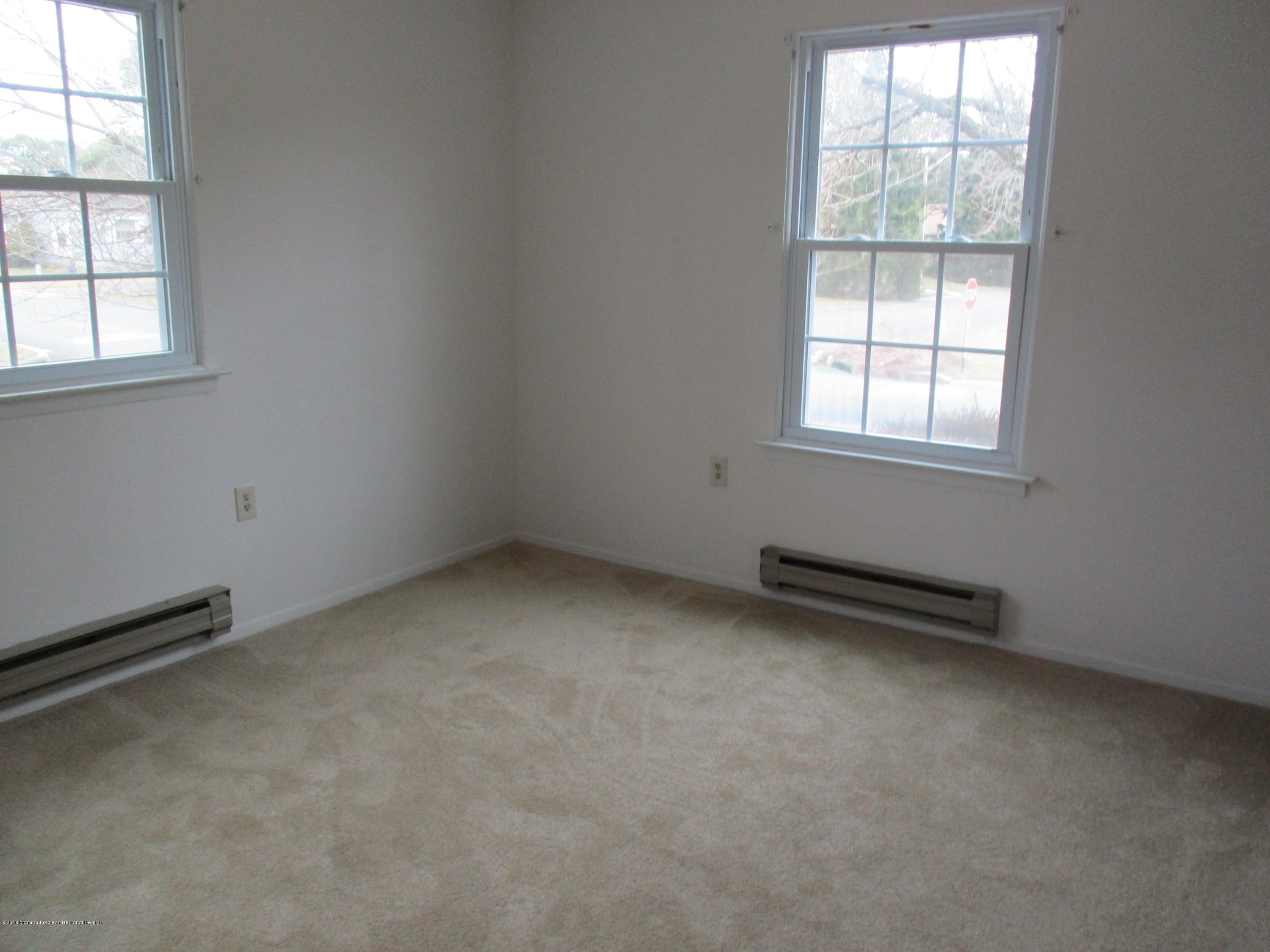 85 Sunset Road, Unit 60 Whiting, NJ 08759 - Photo 10 of 18 an empty room with a window