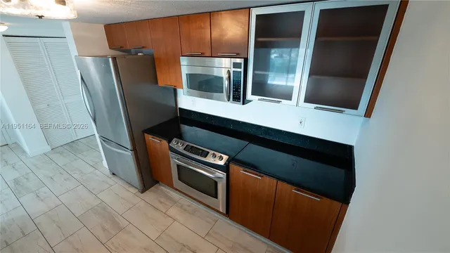 a view of empty room with wooden floor and window