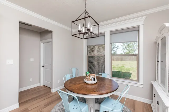a dining room with table and chairs